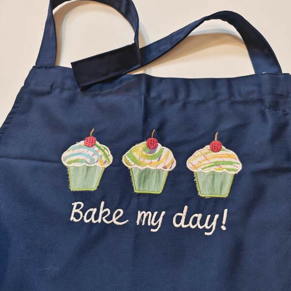 dunkelblaue Schürze mit Muffins